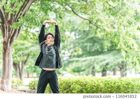 Young Asian man stretching, warming up and warming up before exercise Young Asian man stretching, warming up and warming up before exercise 116045852