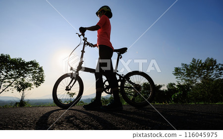 Riding folding bike on sunny mountain top road Riding folding bike on sunny mountain top road 116045975
