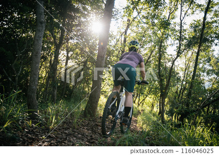 Mountain biking on spring forest trail Mountain biking on spring forest trail 116046025