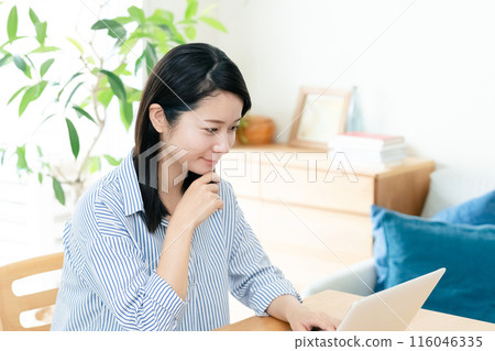 A young lady who operates a personal computer A young lady who operates a personal computer 116046335
