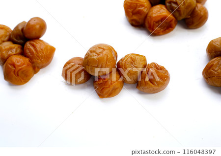 Pickled plums on white background. Pickled plums on white background. 116048397