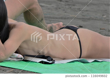 Woman in micro bikini on the beach, summer landscape Woman in micro bikini on the beach, summer landscape 116049602