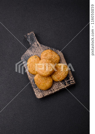 Round fish or chicken nuggets with salt and spices 116050859
