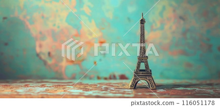 small Eiffel Tower figurine, rustic style background, copy space 116051178