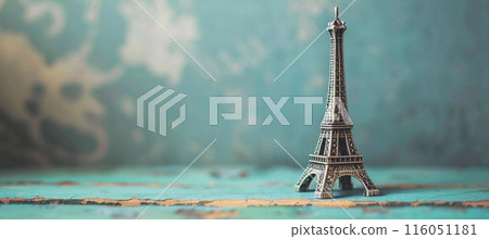 Eiffel Tower figurine, blue retro background, copy space 116051181