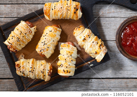 Homemade Sausage in dough rolls on plate 116052101