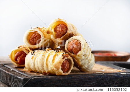 Homemade Sausage in dough rolls on plate 116052102