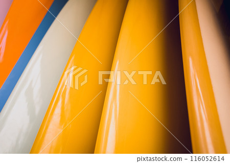 A variety of surfboards are neatly displayed on a stand A variety of surfboards are neatly displayed on a stand 116052614