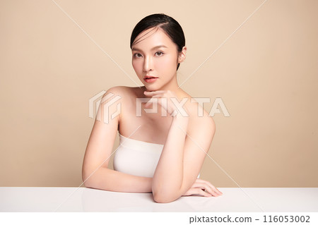 Beautiful young asian woman with clean fresh skin on beige background, Face care, Facial treatment, Cosmetology, beauty and spa, Asian women portrait. Beautiful young asian woman with clean fresh skin on beige background, Face care, Facial treatment, Cosmetology, beauty and spa, Asian women portrait. 116053002