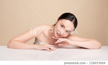 Beautiful young asian woman with clean fresh skin on beige background, Face care, Facial treatment, Cosmetology, beauty and spa, Asian women portrait. 116053004