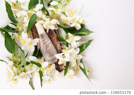 Jasmine essential, bark and Jasmine flowers on white background. Hair treatment. Flat lay Jasmine essential, bark and Jasmine flowers on white background. Hair treatment. Flat lay 116053170