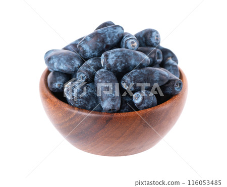 Honeysuckle in wooden bowl, isolated on white background. Fresh honeysuckle blue berry fruits. Clipping path. 116053485