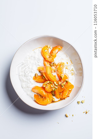 Breakfast cottage cheese with apricot, maple syrup and pistachio. Breakfast cottage cheese with apricot, maple syrup and pistachio. 116053710