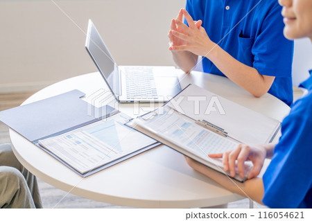 The hands of male and female caregivers having a meeting The hands of male and female caregivers having a meeting 116054621