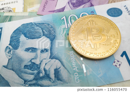 Bitcoin on a stack of Serbian dinar banknotes Bitcoin on a stack of Serbian dinar banknotes 116055470