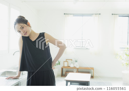 A woman standing in front of the kitchen 116055561
