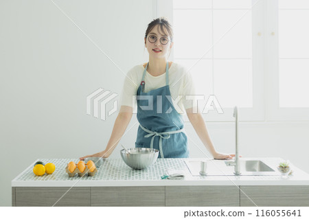 Young woman standing in the kitchen Young woman standing in the kitchen 116055641