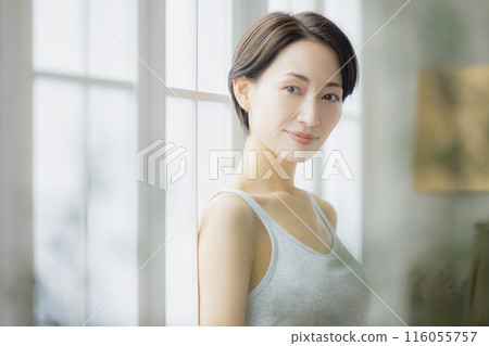 A woman by the window 116055757