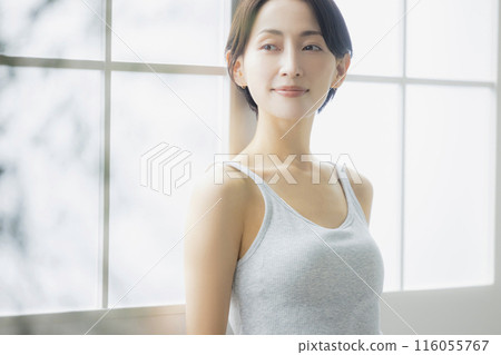 A woman by the window 116055767