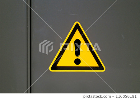 Potential danger sign on a metal door 116056181