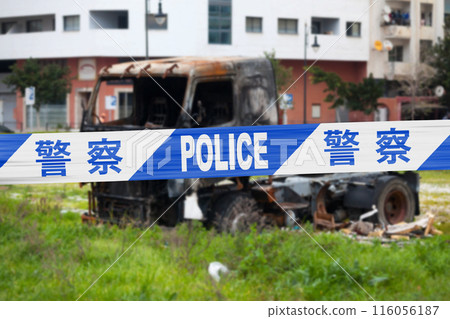Chinese police tape barricading a burnt truck Chinese police tape barricading a burnt truck 116056187