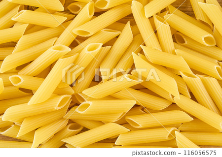 Dried pasta on a wooden board Dried pasta on a wooden board 116056575