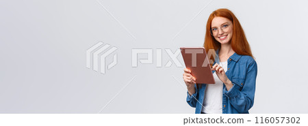 Waist-up portrait friendly happy redhead female student browsing online shops, holding digital tablet, picking new internet course for learning, smiling carefree looking camera, white background Waist-up portrait friendly happy redhead female student browsing online shops, holding digital tablet, picking new internet course for learning, smiling carefree looking camera, white background 116057302