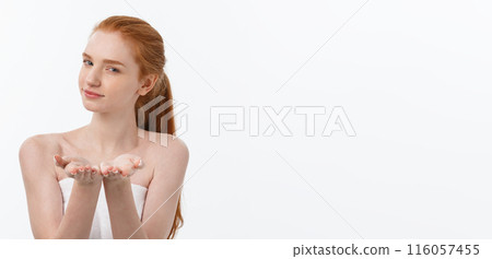 Skin care beauty woman showing empty palm with copy space for product. Excited smiling Caucasian female beauty model isolated on white background. Skin care beauty woman showing empty palm with copy space for product. Excited smiling Caucasian female beauty model isolated on white background. 116057455