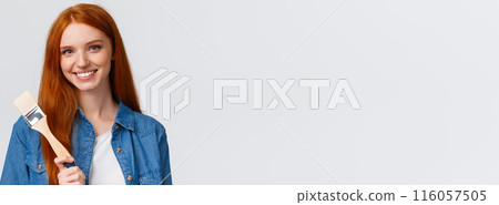 Close-up portrait talented and creative cute redhead girl with blue eyes like drawing, attend art courses, holding painting brush, consider paint walls new color, smiling confident, white background 116057505