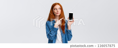 Tempting and curious attractive redhead woman found delicious meal on food delivery application, adding it to shopping card, want buy take-away, pointing smartphone screen, white background 116057875