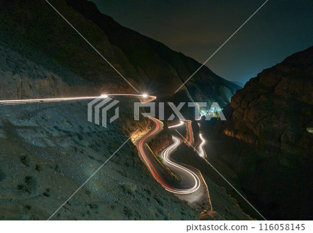 car driving on a winding road in the mountains car driving on a winding road in the mountains 116058145