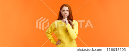 Serious and mad elder sister say keep silent, forbid talking during class, shushing angry with index finger pressed mouth, hold hand on waist in dissatisfied pose, standing orange background Serious and mad elder sister say keep silent, forbid talking during class, shushing angry with index finger pressed mouth, hold hand on waist in dissatisfied pose, standing orange background 116058203