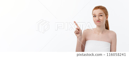 Portrait of caucasian cute in concern and shock, pointing index finger aside, over white background. 116058241