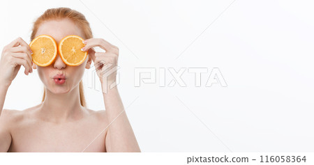 Great food for a healthy lifestyle. Beautiful young shirtless woman holding piece of orange standing against white background. 116058364