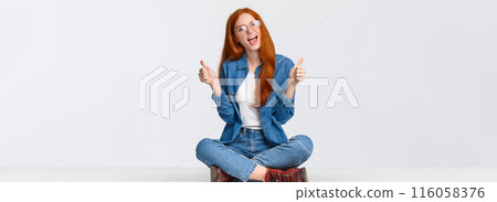 Yeah go for it. Excited and sassy good-looking assertive redhead teenage girl with red foxy haircut, sitting crossed legs on floor, showing thumbs-up and saying yes, recommend, approve something Yeah go for it. Excited and sassy good-looking assertive redhead teenage girl with red foxy haircut, sitting crossed legs on floor, showing thumbs-up and saying yes, recommend, approve something 116058376