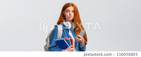 Indecisive, nervous cute redhead freshman girl, start new year college, looking worried camera, biting lip nervously, holding backpack, notebooks and smartphone, reading message 116058803