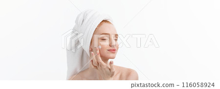beautiful model applying cosmetic cream treatment on her face on white. beautiful model applying cosmetic cream treatment on her face on white. 116058924
