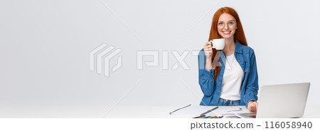 Cheerful and energized good-looking redhead female freelancer, drink too much coffee smiling excited and thrilled, working over creative cool project, using laptop, drawing, white background 116058940