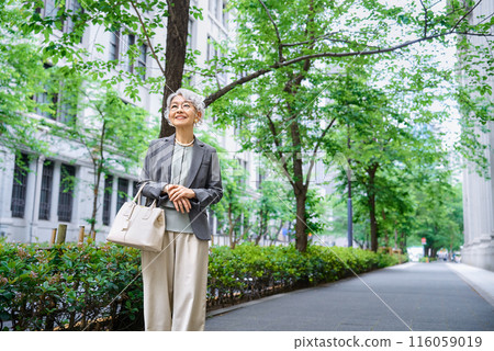 老婦人拎著包出門 116059019