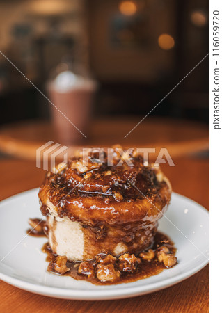 Caramel bun bakery dessert served on table in the cafe. 116059720