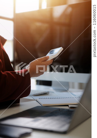 .Cropped image of professional businesswoman working at her office via laptop, young female manager using portable computer device while sitting at modern loft, flare light, work process concept .Cropped image of professional businesswoman working at her office via laptop, young female manager using portable computer device while sitting at modern loft, flare light, work process concept 116060015