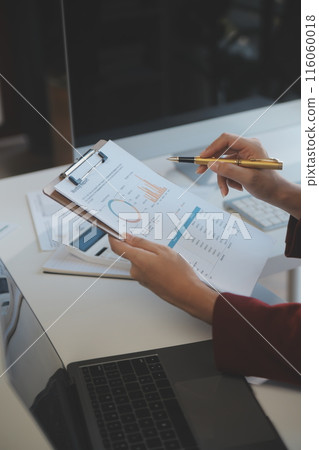 .Cropped image of professional businesswoman working at her office via laptop, young female manager using portable computer device while sitting at modern loft, flare light, work process concept .Cropped image of professional businesswoman working at her office via laptop, young female manager using portable computer device while sitting at modern loft, flare light, work process concept 116060018