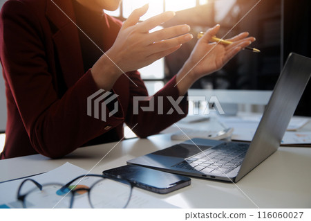 .Cropped image of professional businesswoman working at her office via laptop, young female manager using portable computer device while sitting at modern loft, flare light, work process concept .Cropped image of professional businesswoman working at her office via laptop, young female manager using portable computer device while sitting at modern loft, flare light, work process concept 116060027