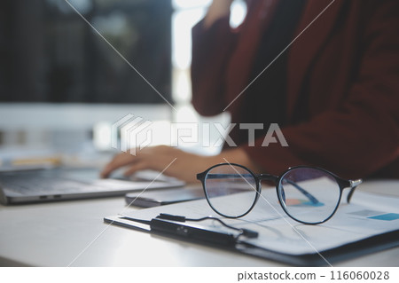 .Cropped image of professional businesswoman working at her office via laptop, young female manager using portable computer device while sitting at modern loft, flare light, work process concept .Cropped image of professional businesswoman working at her office via laptop, young female manager using portable computer device while sitting at modern loft, flare light, work process concept 116060028