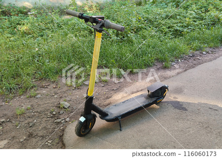 An electric scooter is left at the end of the road. An electric scooter is left at the end of the road. 116060173