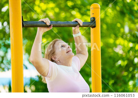 Elderly woman exercising. Fit senior lady running. 116061053