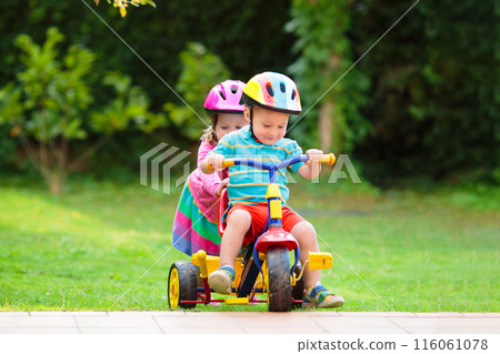 Two children riding bikes 116061078
