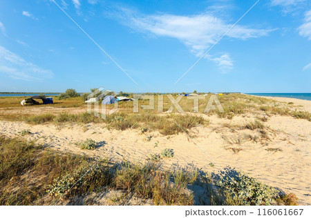 Camping in sandy prairie between lake and sea 116061667