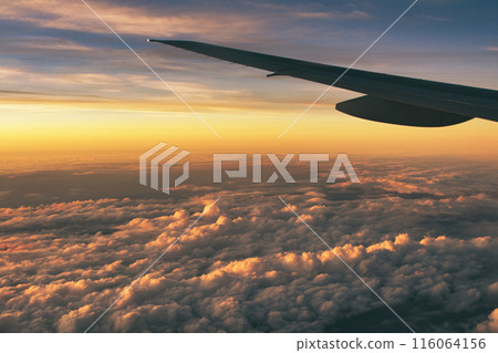 A tranquil sunset seen from an airplane A tranquil sunset seen from an airplane 116064156
