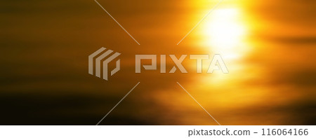 A duotone banner background in which the golden setting sun shines on the black sea surface (image with illustration-like processing and color processing) 116064166
